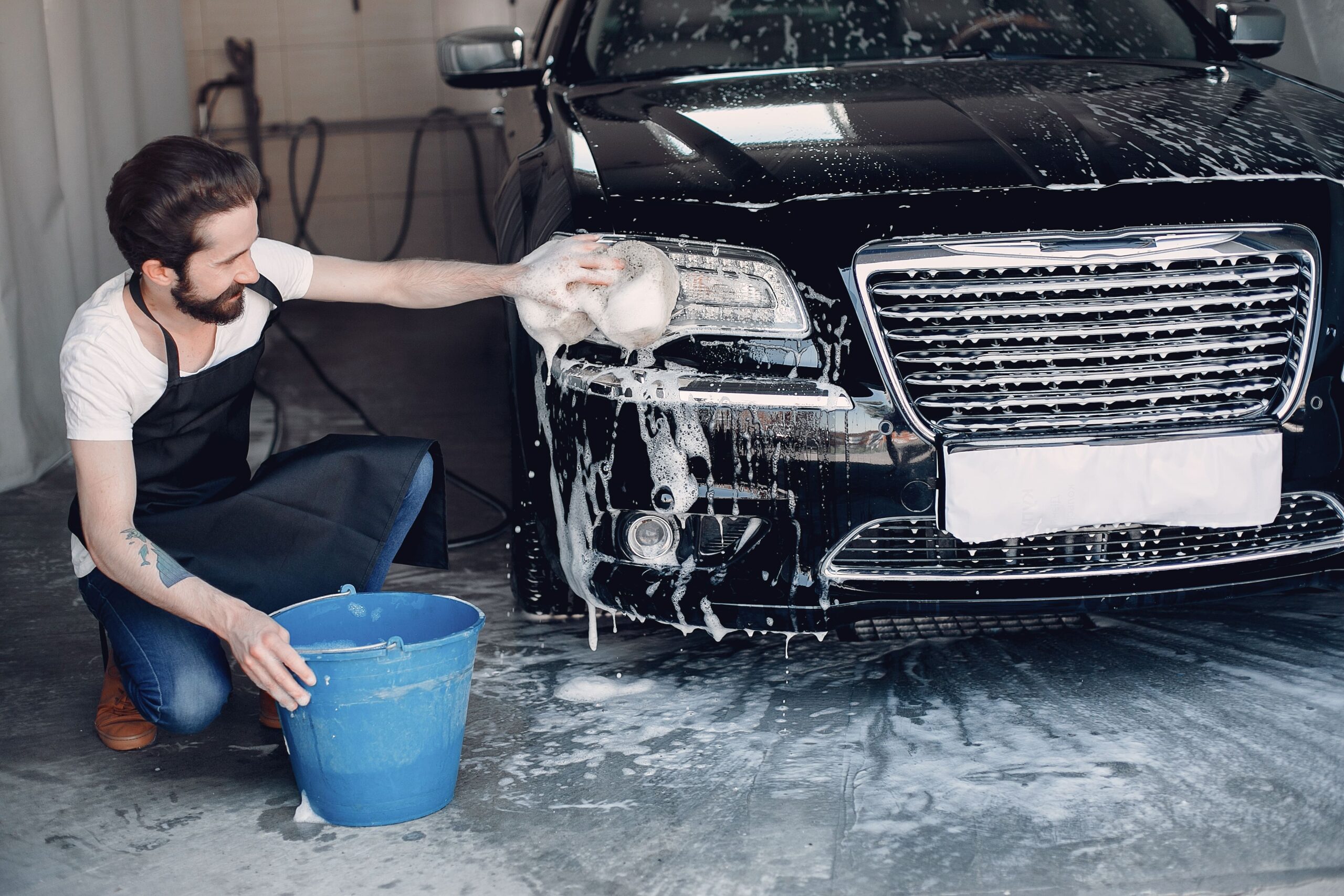 man-washing-his-car-garage-min